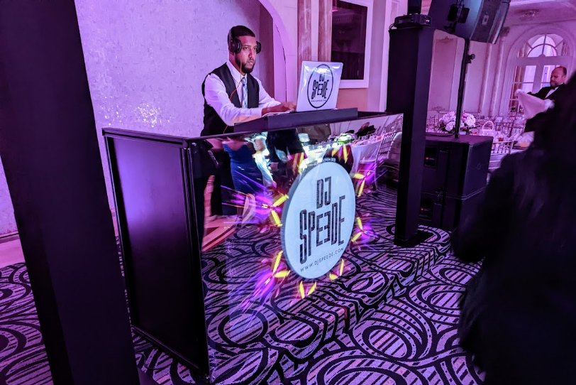 DJ performing behind a lit booth