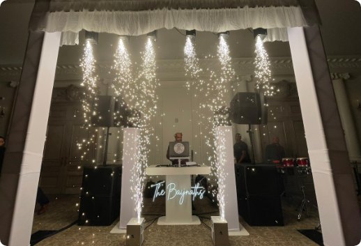DJ booth framed by a curtain of cold sparks